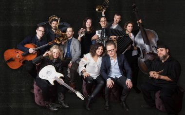 Anat Cohen in the middle in a white blouse with the Tentet surrounding her with their instruments. 