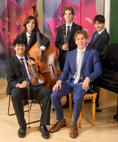 Five young classical musicians with their instruments.