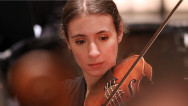 A young women plays the viola.