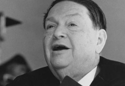 Elderly Darius Milhaud holding score with mouth agape.