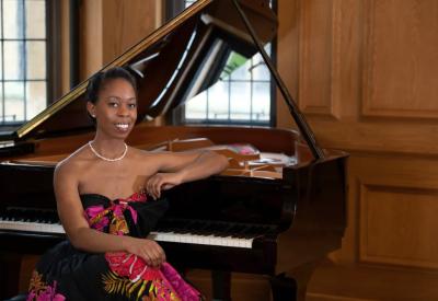 Samantha Ege sits at a piano.