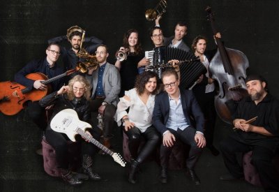 Anat Cohen in the middle in a white blouse with the Tentet surrounding her with their instruments. 