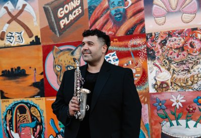 Solo shot of Michael Hernandez against a colorful mural