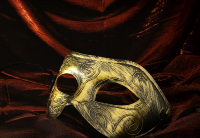 image of gold half-mask against red velvet