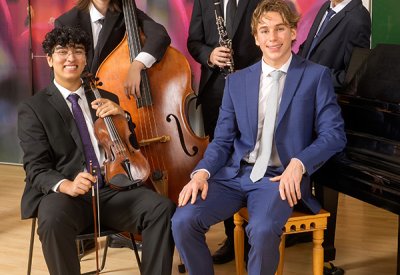 Five young classical musicians with their instruments.