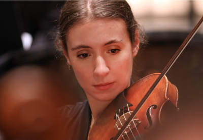 A young women plays the viola.