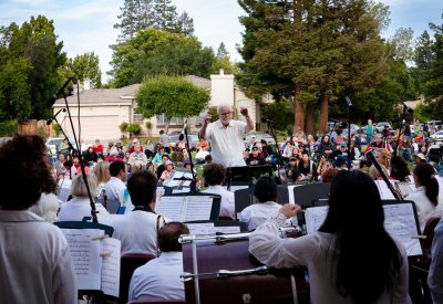 conducting an orchestra, outdoors