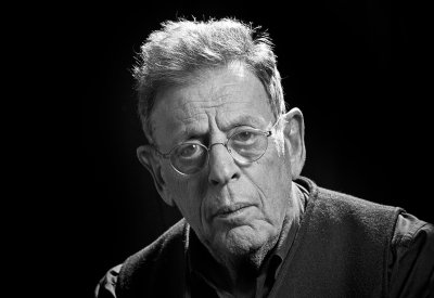 Portrait of Philip Glass in black and white. 