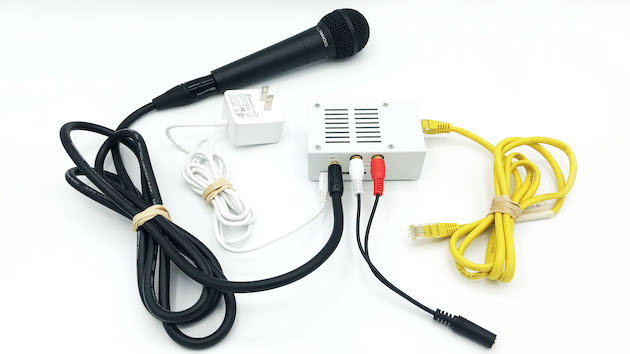 The JackTrip Virtual Studio with the key components necessary for a basic setup: microphone, headphone adapter, ethernet cable, and USB power source
